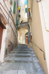 Fototapeta na wymiar ITALY EMPIRE - JULY 14, 2014: View of the alley with stairs up t