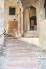ITALY EMPIRE - JULY 14, 2014: View of the alley with stairs up t
