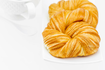 Closeup fresh and tasty croissant on white background