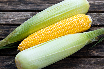 close up Fresh Ripe Sweetcorn on old wooden table. ready to cook