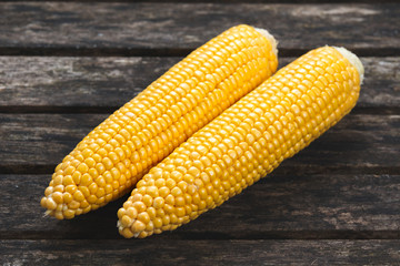 close up Fresh Ripe Sweetcorn on old wooden table. ready to cook