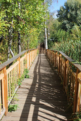Naklejka na ściany i meble Wooden bridge in a Park in autumn