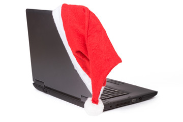 Rote Weihnachtsmütze auf dem Notebook-Computer