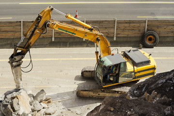 large machine excavator vehicle destroying pavement in construction site for the highway repair © GDM photo and video