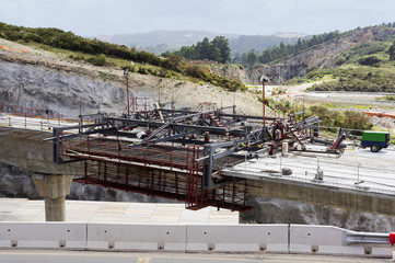 workers in construction site working in the bridge girders between the pillars with a metal formwork