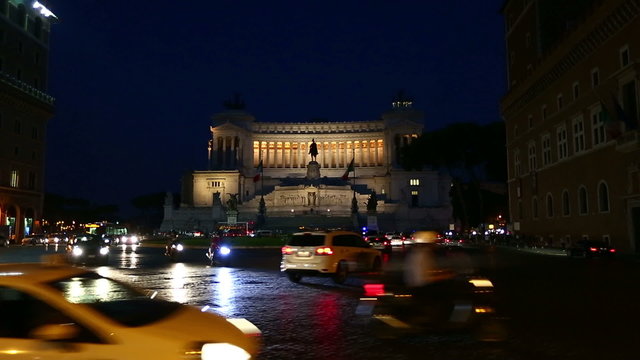Night Pan Shot Vittorio Emanuele Monument with City Traffic at Piazza Venezia in Rome Lazio Italy