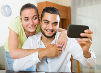 couple taking selfie with smartphone