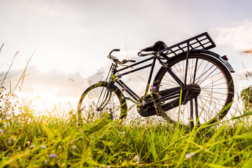 Naklejka na ściany i meble beautiful landscape image with Bicycle at sunset