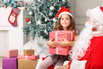 Pretty girl sitting with Santa 