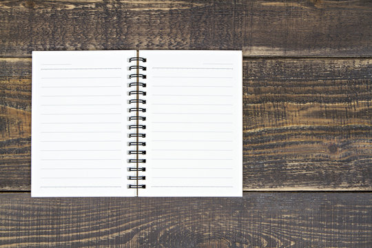 Notebook on wooden background.