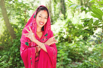 young beautiful nepalese woman wearing saree standing in a nature
