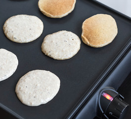 Oat pancakes cooking on electric barbecue