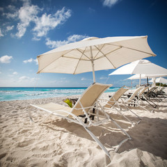 Beach with sun umbrellas and beds