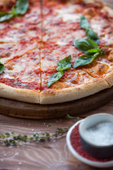 Italian pizza with basil leaves