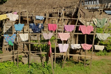 Child's clothes and rags drying on a house