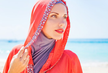 beautiful muslim caucasian (russian) woman wearing red dress rel
