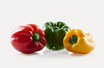 Fresh vegetables. Three sweet Red, Yellow, Green Peppers isolate