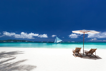 Parasols et lits en bois sur la plage tropicale