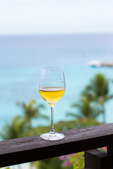 Glass of white wine on balcony rail
