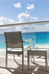 Balcony with plastic bottle of water on  table overlooking an oc