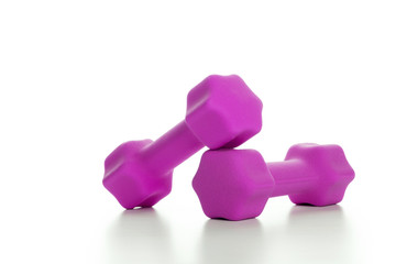 Fitness concept with two pink dumbbells on white background