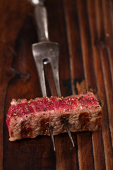 beef steak Slice on vintage meat fork