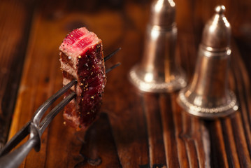 beef steak Slice on vintage meat fork