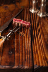 beef steak Slice on vintage meat fork