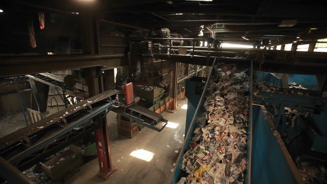 Recycled materials travel on a conveyor belt at a recycling center.