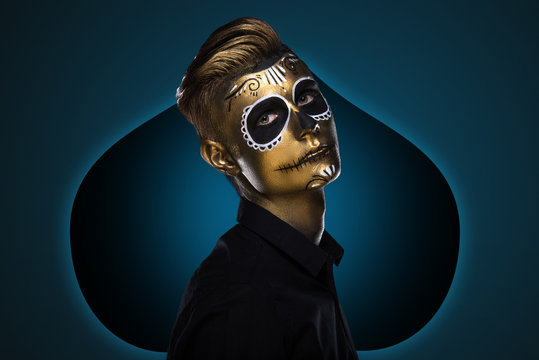 The guy with the painted face for Halloween. Masquerade Party. Night festivities dressed as zombies. Face art