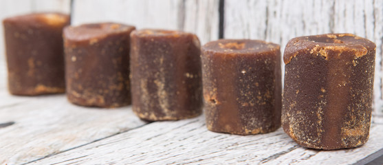 Brown coconut sugar over wooden background