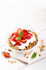 Yogurt with granola and fresh strawberries