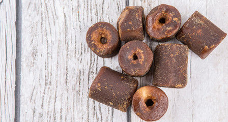 Brown coconut sugar over wooden background