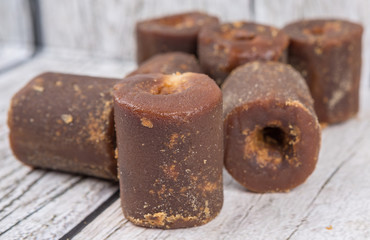 Brown coconut sugar over wooden background