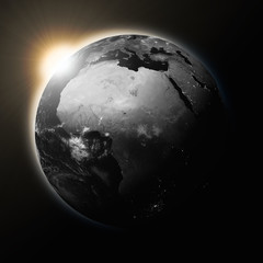 Obraz na płótnie Canvas Sun over Africa on dark planet Earth