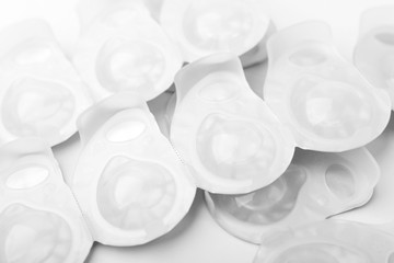 Several packs of contact lens on white surface.