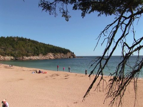 People relax on a beach in Acadia National Park in Maine.