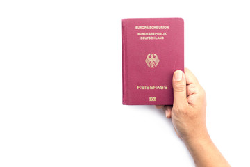 Close up hand holding German passport isolated on white