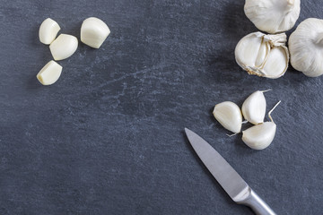 Garlic bulb and single cloves on slate
