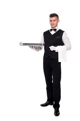 Portrait of young happy smiling waiter with on tray isolated on