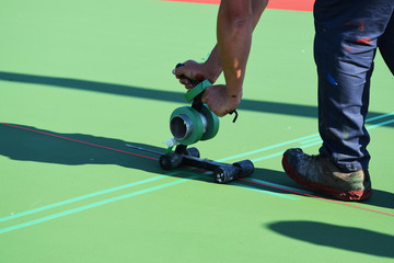 Masking to paint lines on tennis court