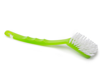 Green dish washing brush on white