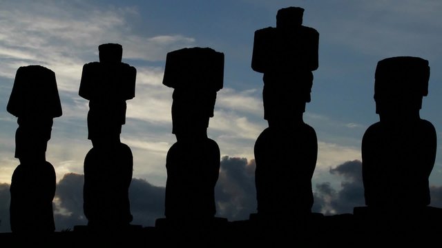 Clouds move behind Easter Island statues.