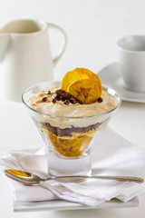 Cottage cheese and banana dessert in a glass on a restaurant table.