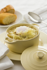 French onion soup in small ceramic cooking pot