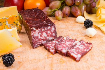 Sliced Cured Meat on Gourmet Cheese Board