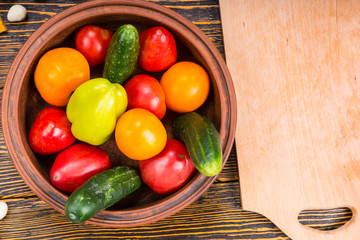 Bowl of Fresh Picked Vegetables Beside Wood Board