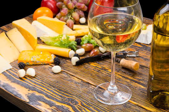 Glass of White Wine on Table with Cheese and Fruit