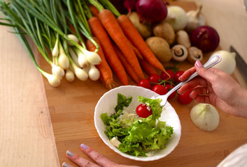 Young Woman Cooking in the kitchen. Healthy Food
