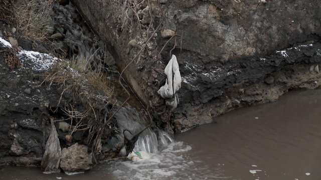 Polluted water flows into an irrigation ditch.